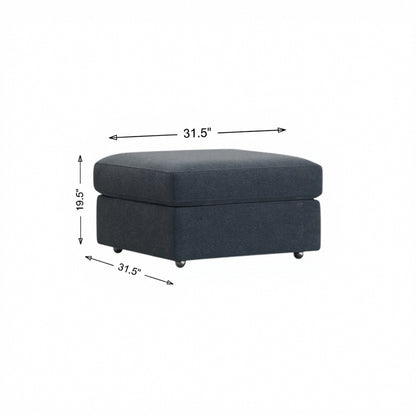Storage ottoman in dark navy fabric, hinged lid and four tapered legs.