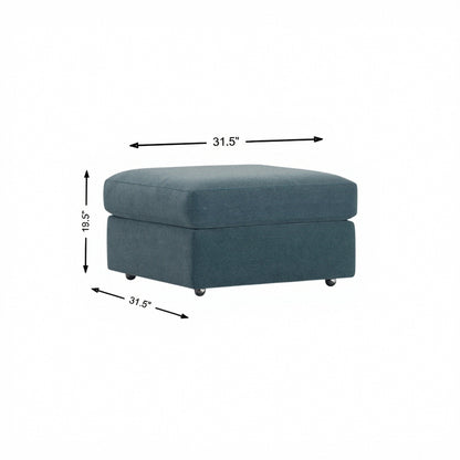 Storage ottoman in teal fabric, cushioned hinged lid and tapered legs.