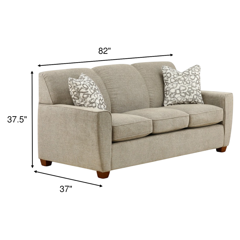 Light beige fabric sofa with two patterned accent pillows and squared arms