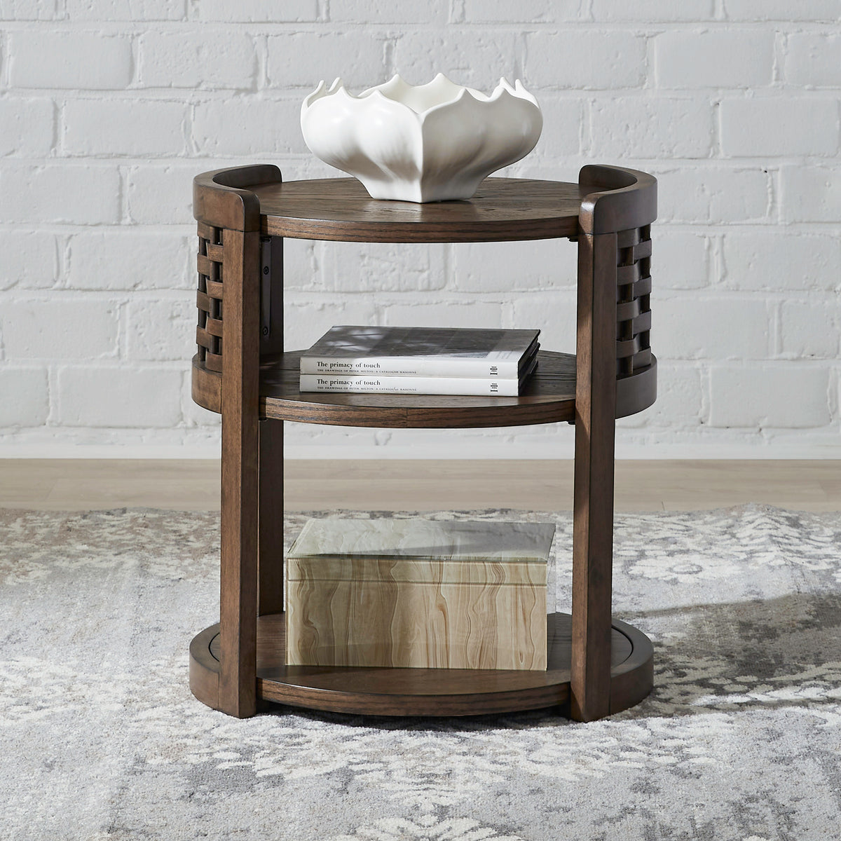 Dark wood round chairside table with top tray, lower shelf, and woven side rails