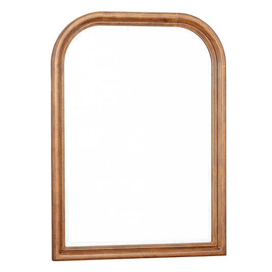 Arched wood-framed bedroom mirror with warm brown finish