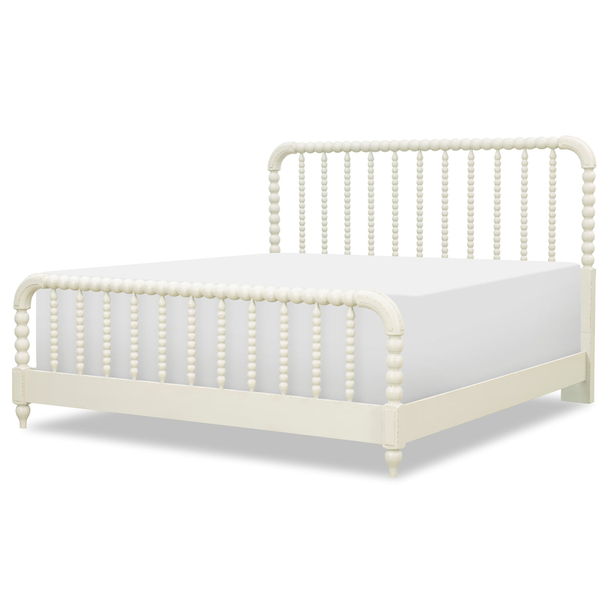 Cream panel bed angled view with arched headboard top and vertical beadboard posts.