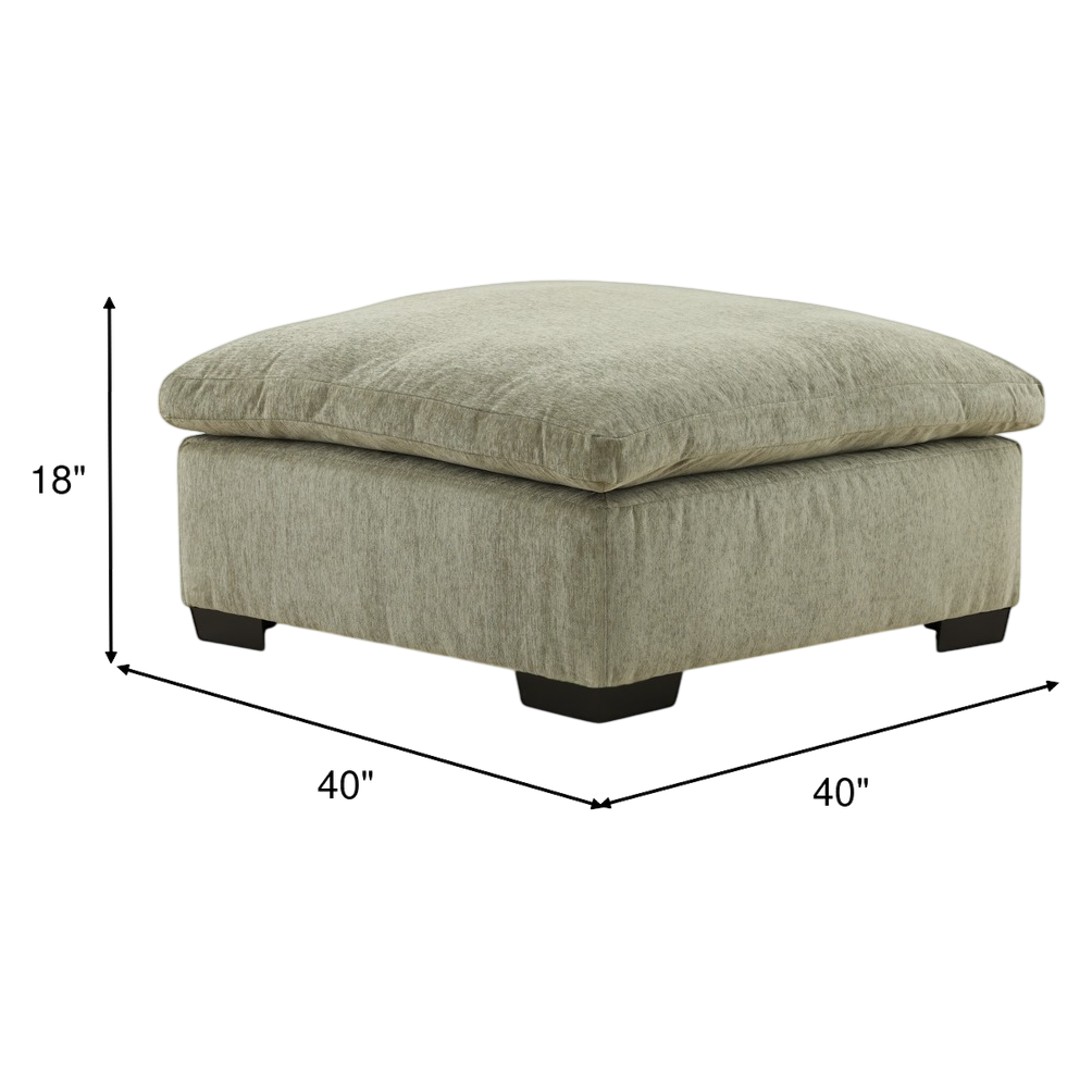 Light green upholstered ottoman with tufted square top and black block legs