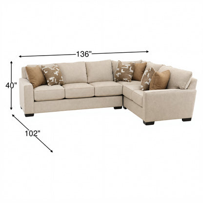 Beige L-shaped sectional sofa with square arms and several throw pillows