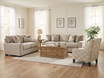 Beige upholstered sofa with patterned throw pillows