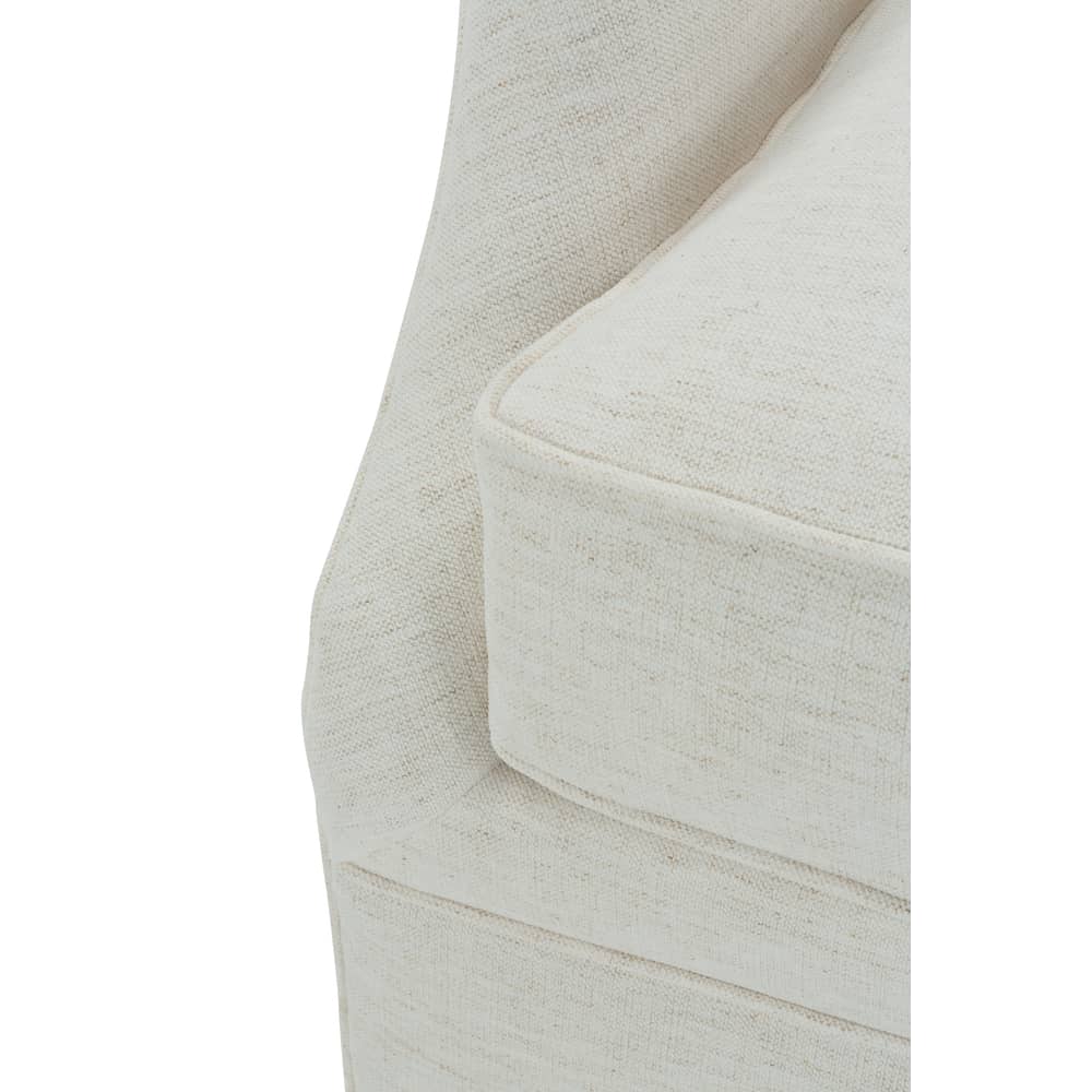Light beige upholstered glider chair arm and side panel with welt stitching