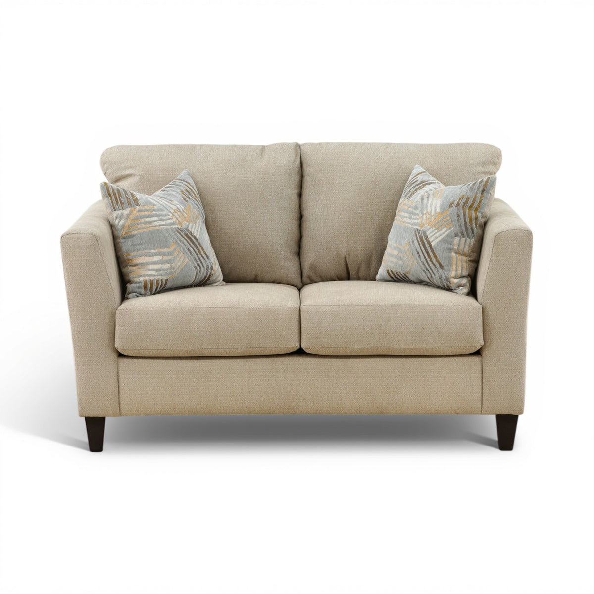 Light beige upholstered loveseat with two patterned accent pillows and square arms