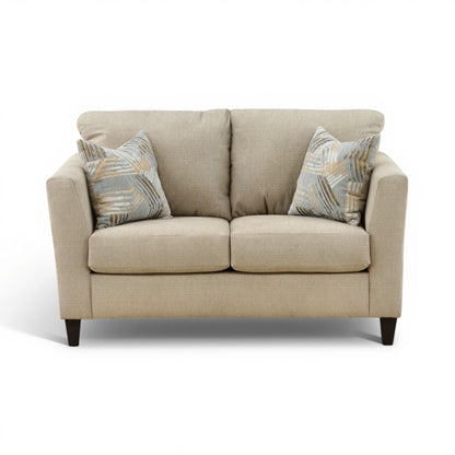 Light beige upholstered loveseat with two patterned accent pillows and square arms