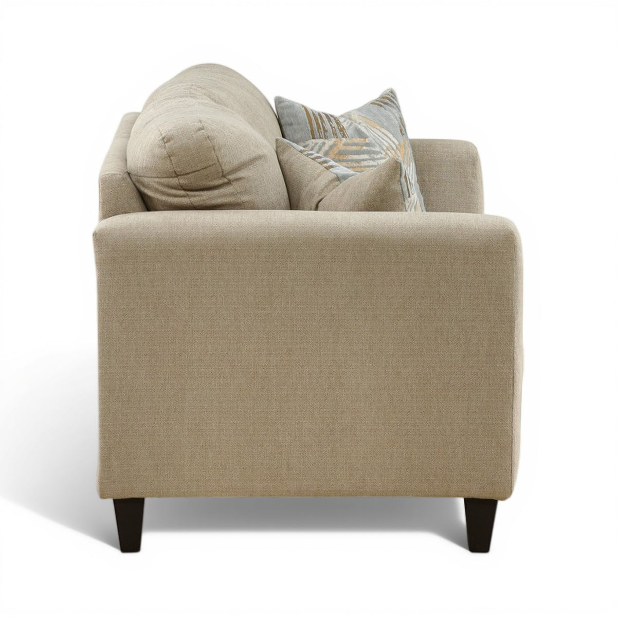 Light beige upholstered loveseat backrest with two patterned accent pillows