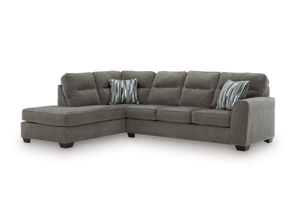Graphite sectional with left-facing chaise, cushioned back and two striped accent pillows.