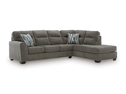 Graphite sectional with right-facing chaise, cushioned back and two striped accent pillows.