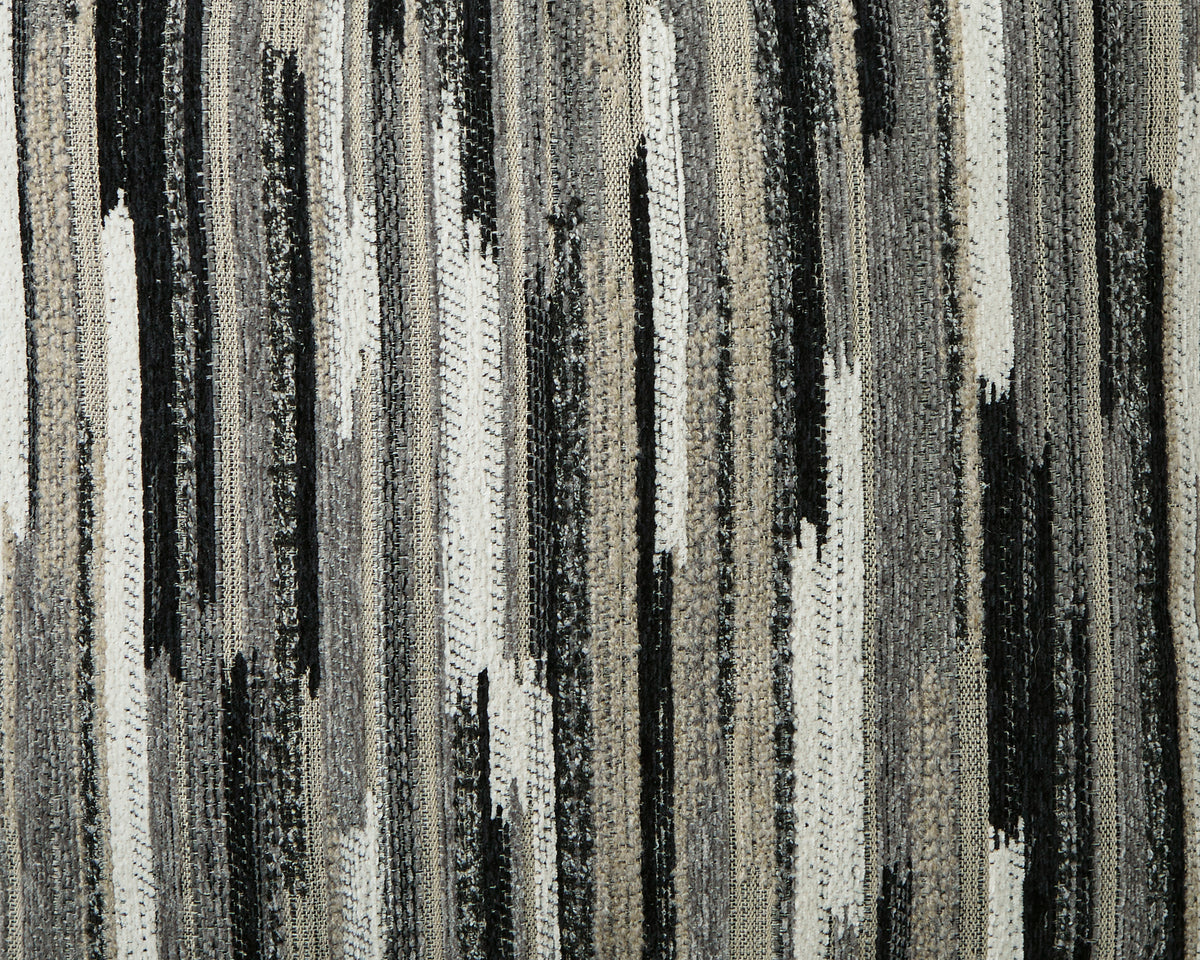 Close-up of the sectional's woven upholstery in gray, cream, and black