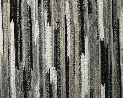 Close-up of the sectional's woven upholstery in gray, cream, and black