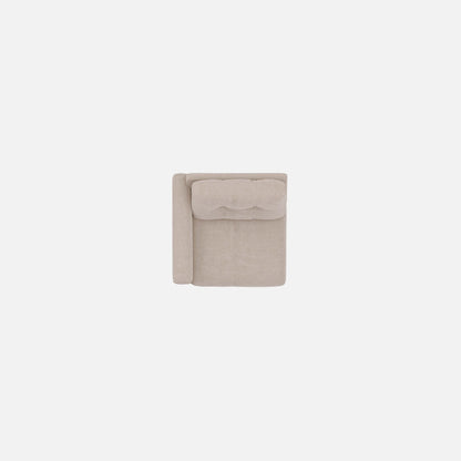 Light beige modular chair shown from front with tufted back and padded arms