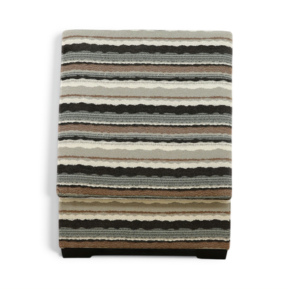 Striped fabric storage ottoman with dark base and quilted top