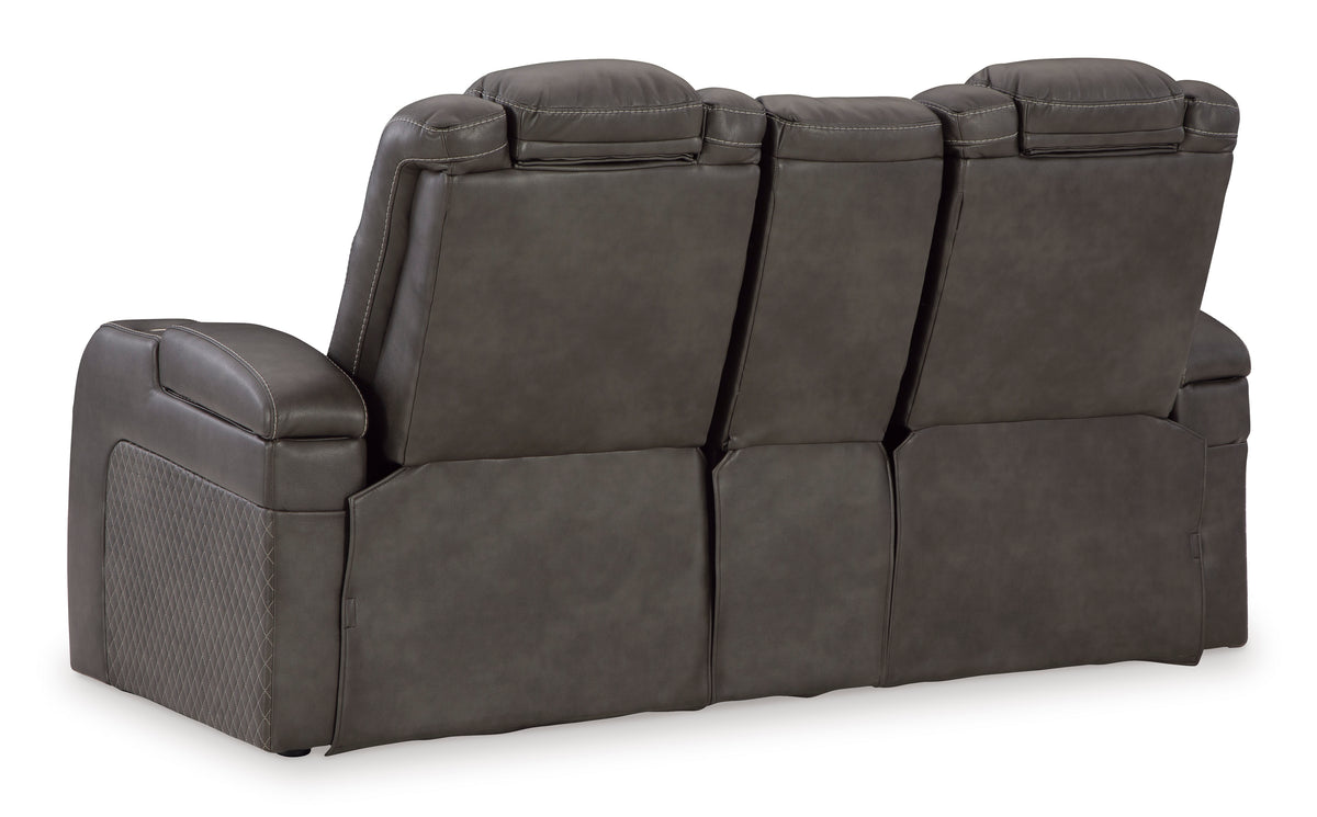 Dark gray reclining loveseat with rounded arms and stacked back cushions