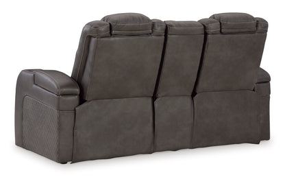 Dark gray reclining loveseat with rounded arms and stacked back cushions
