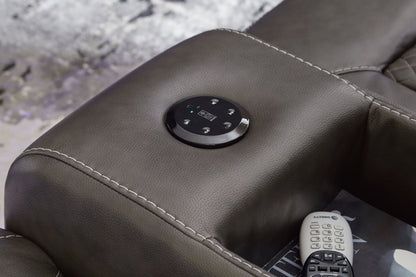Reclining control button on dark armrest with remote