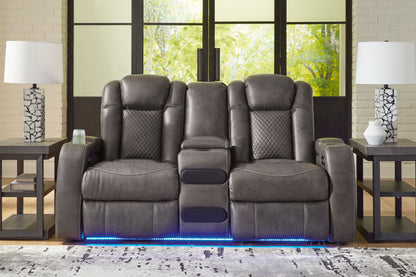 Dark gray dual power reclining loveseat with center console and blue LED base strip