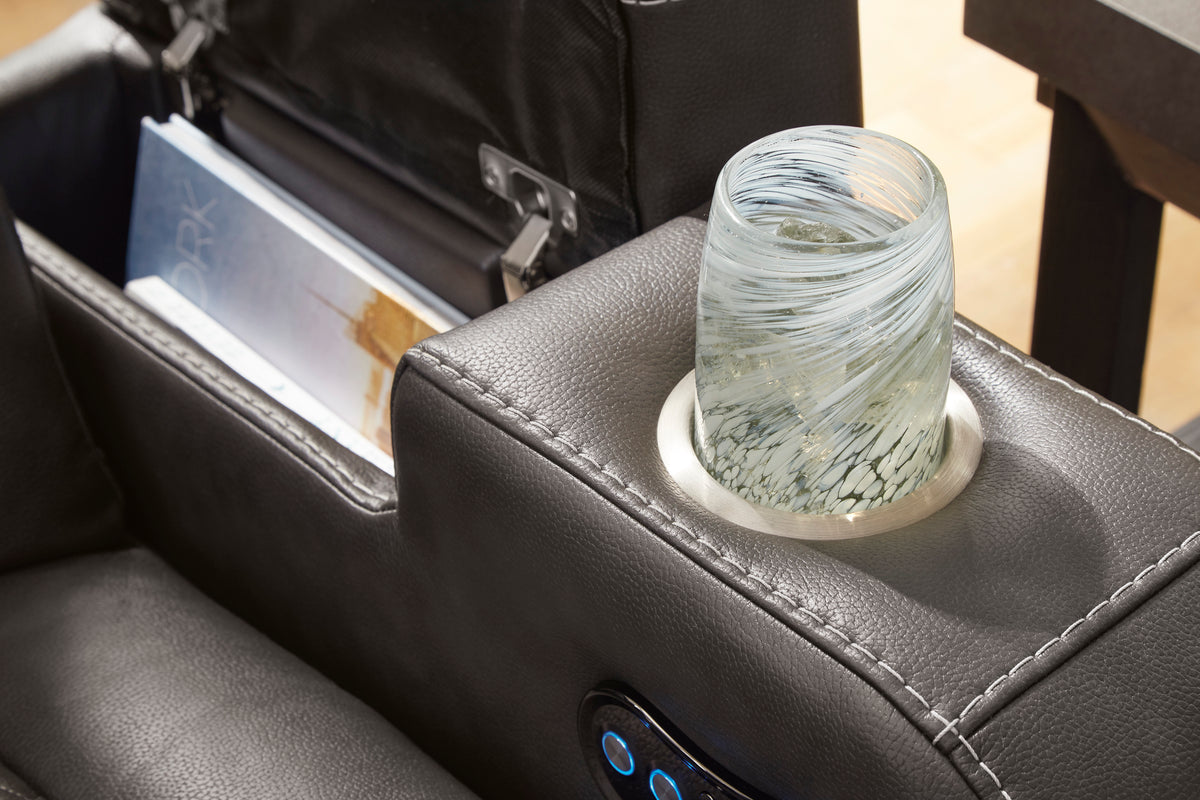 Console cup holder on dark gray dual recliner with stitched edge and blue control light