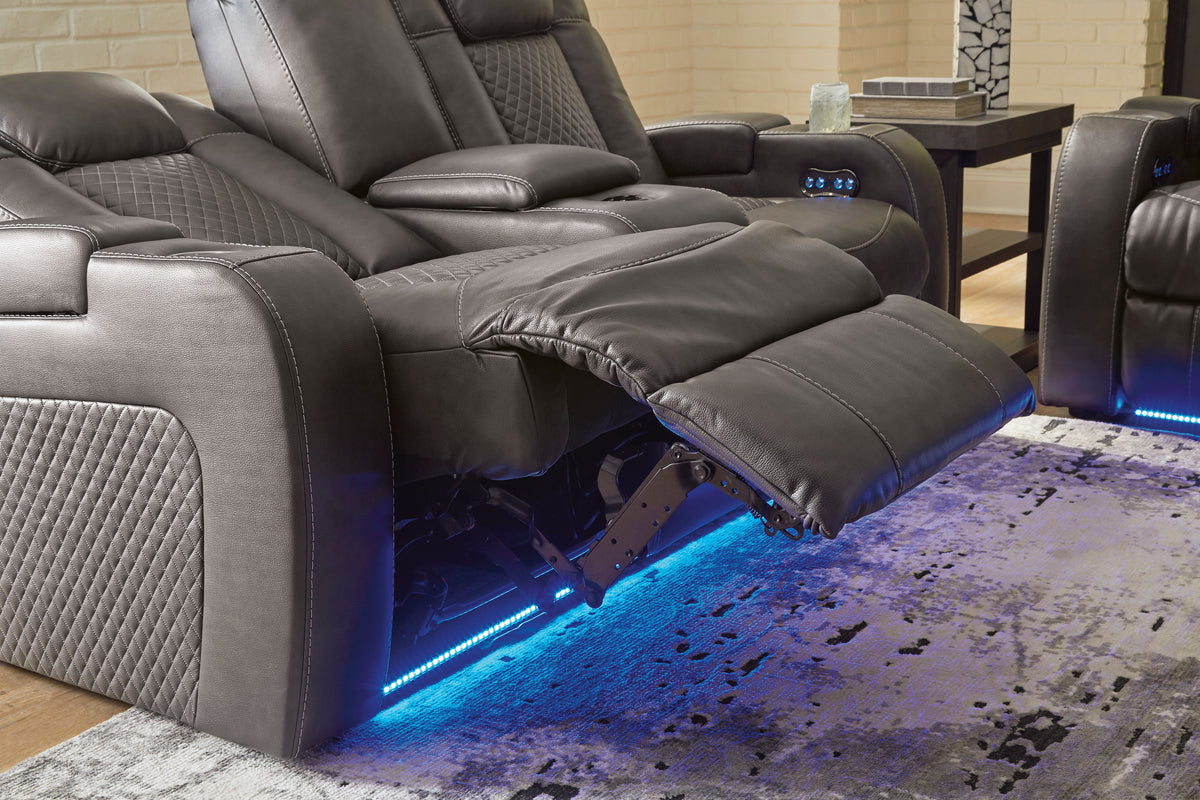 Dual power reclining loveseat with console in dark gray, open footrest and blue LED lights