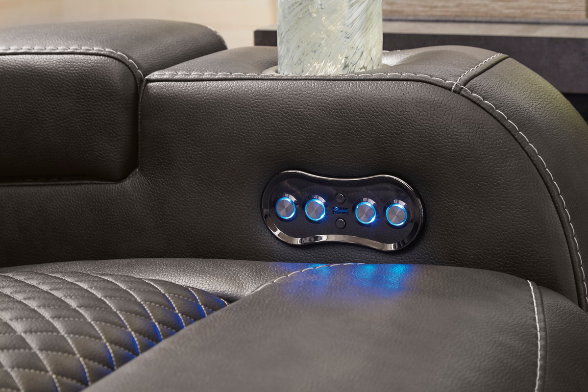 Power button panel on dark padded armrest with glowing blue lights