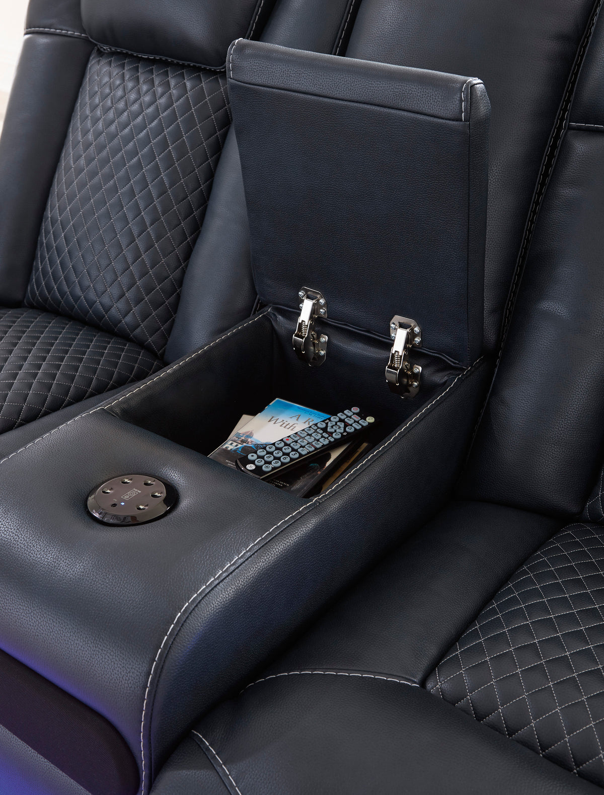 Black console armrest with hinged tray and two metal latches