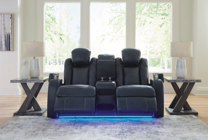 Dark power reclining loveseat with console and blue LED strip at the base, front view