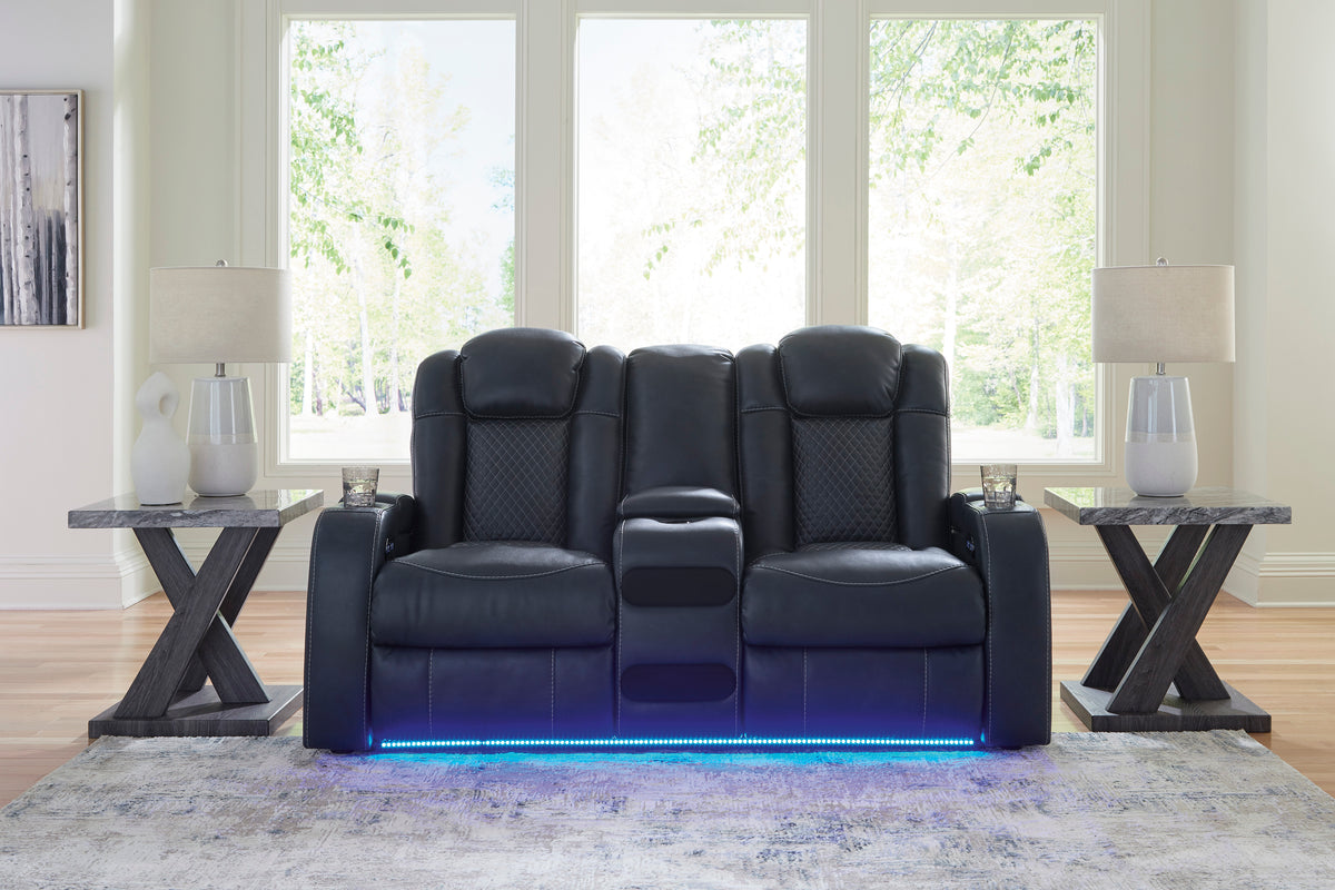 Dark power reclining loveseat with blue LED base in a bright living room