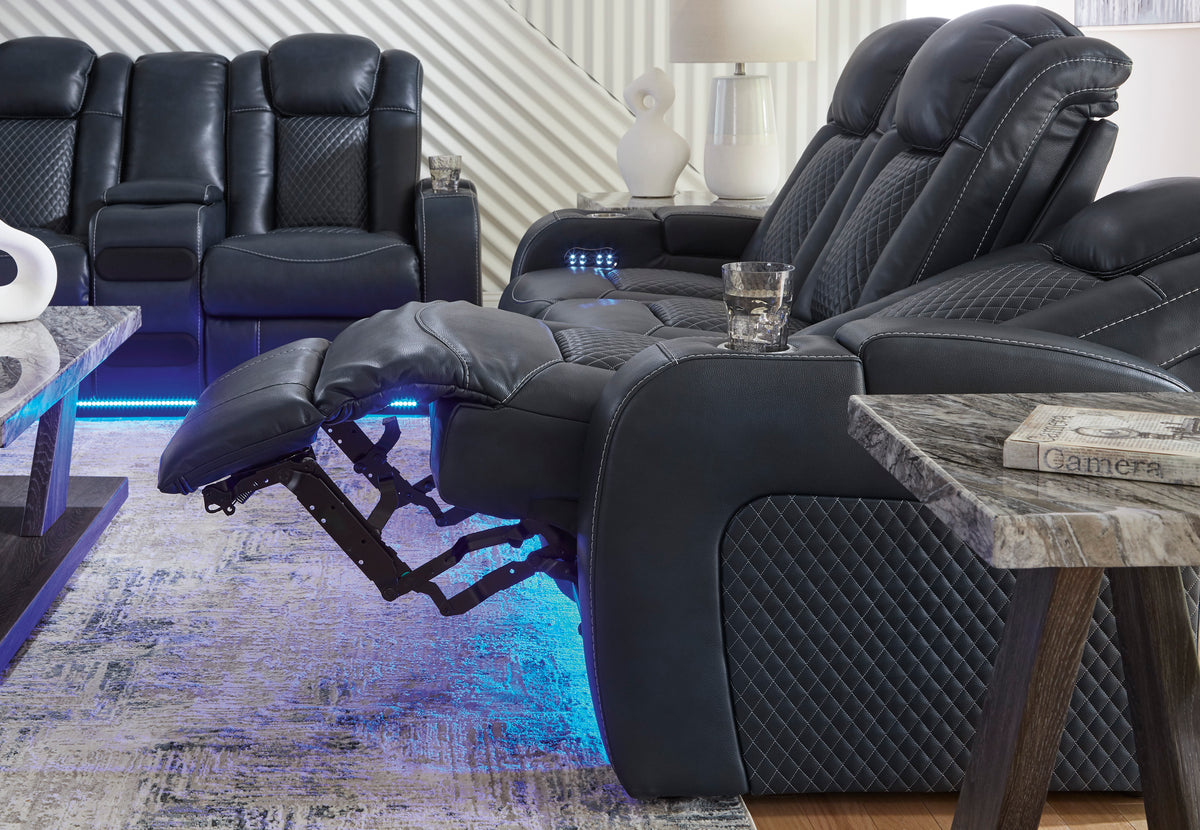 Black reclining loveseat with center console and blue-lit controls
