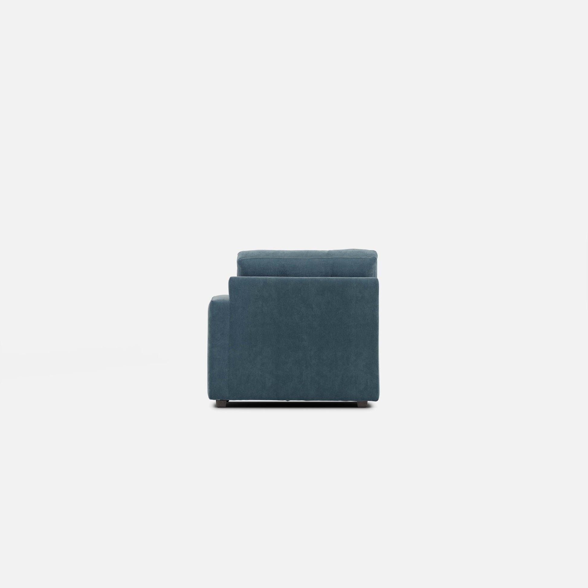 Modular chair in teal fabric shown from front-left with tall back and boxy frame.