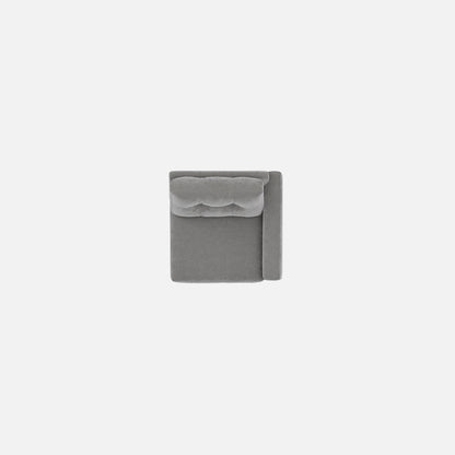 Gray upholstered modular chair with tufted back and compact square silhouette