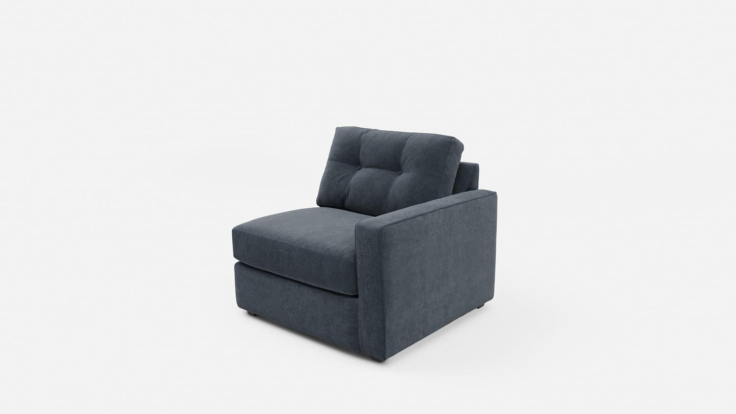 Upholstered armchair in dark navy with tufted back, short armrests, and block base