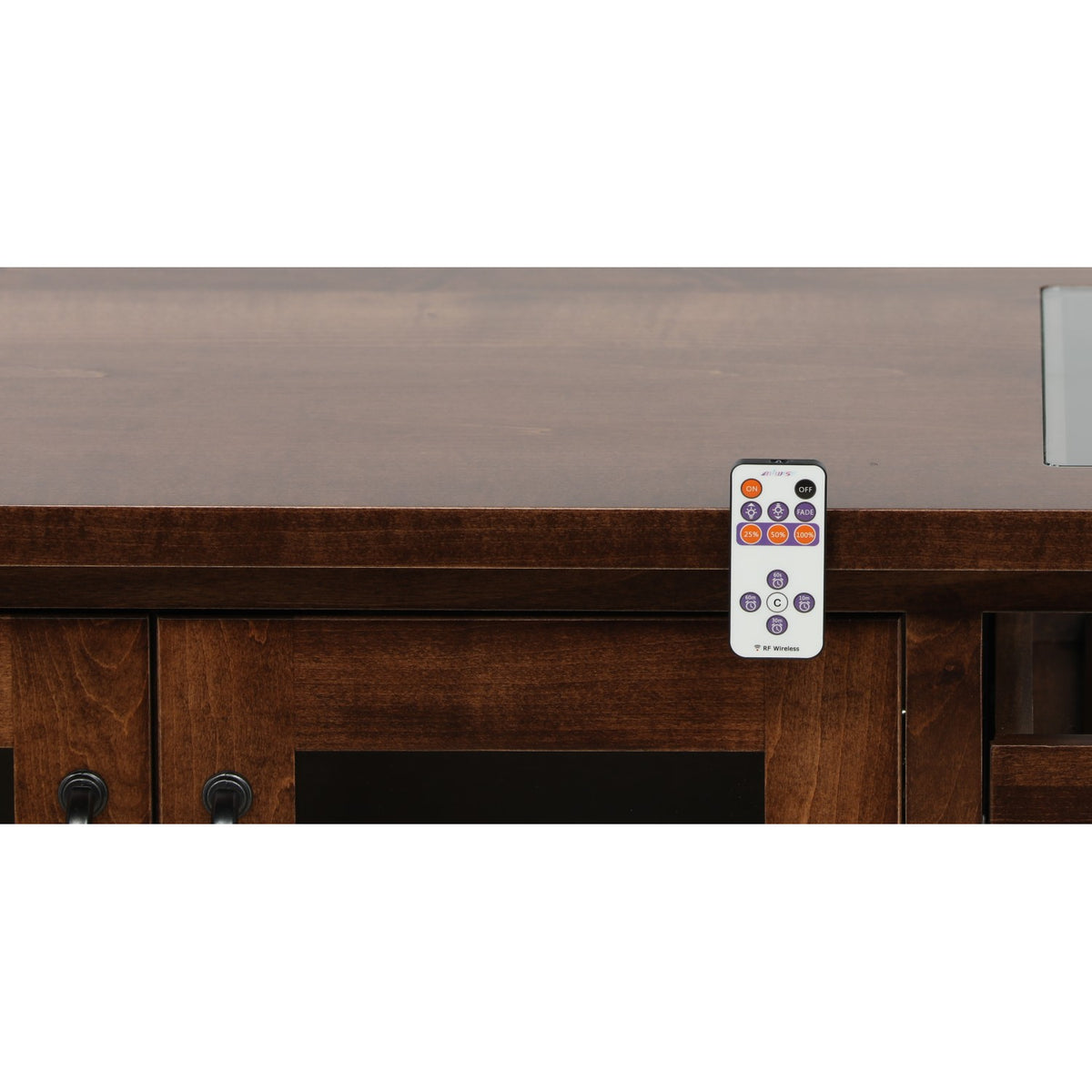 Wooden cabinet front with gray top and RF wireless remote resting near the opening