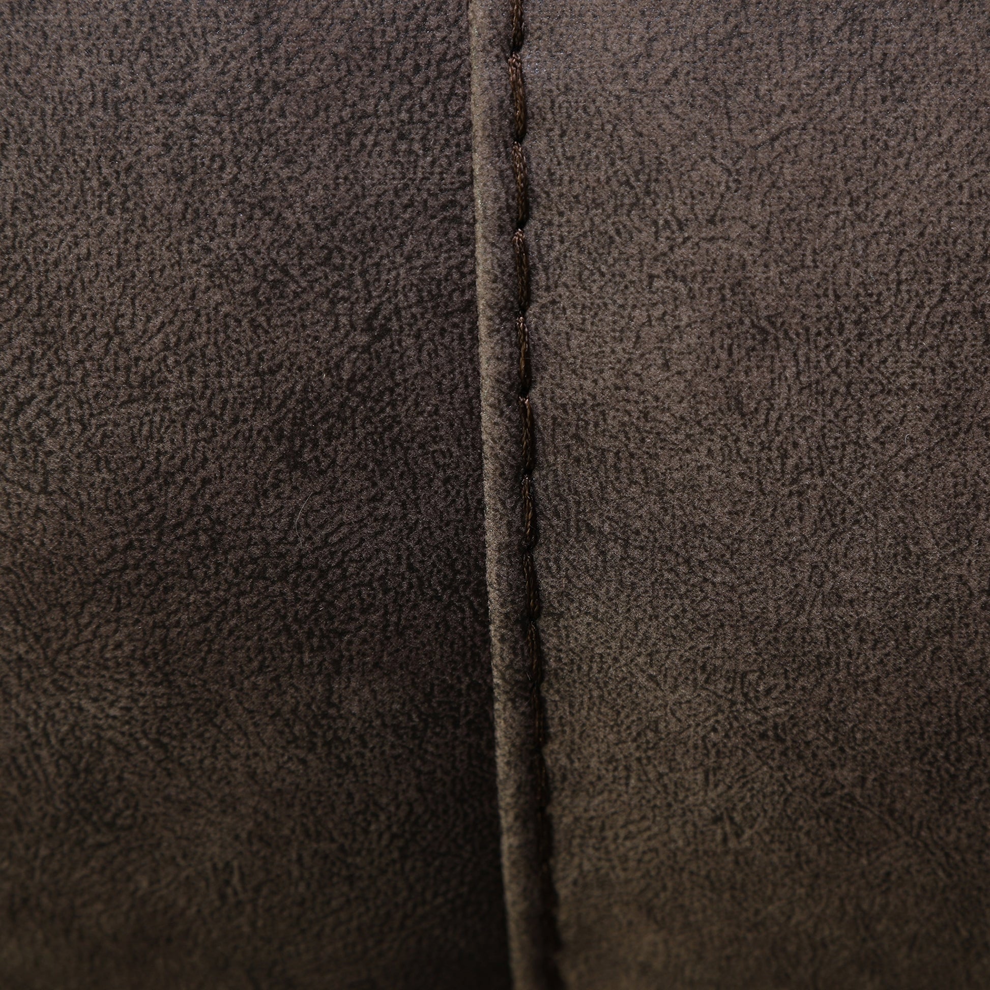 Wall-hugging power recliner side seam close-up with dark brown faux leather stitching