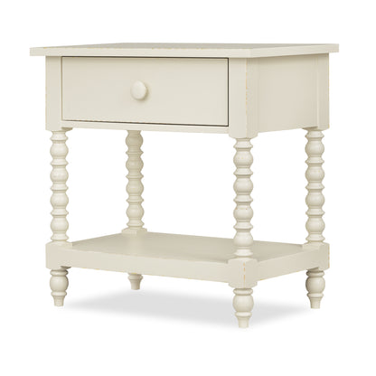 White nightstand with one drawer, open lower shelf, and turned spindle legs.