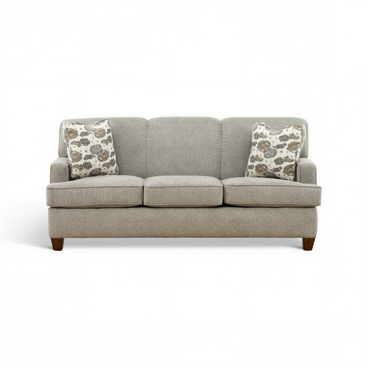 Beige 3-seat sofa with two patterned throw pillows and dark wood legs