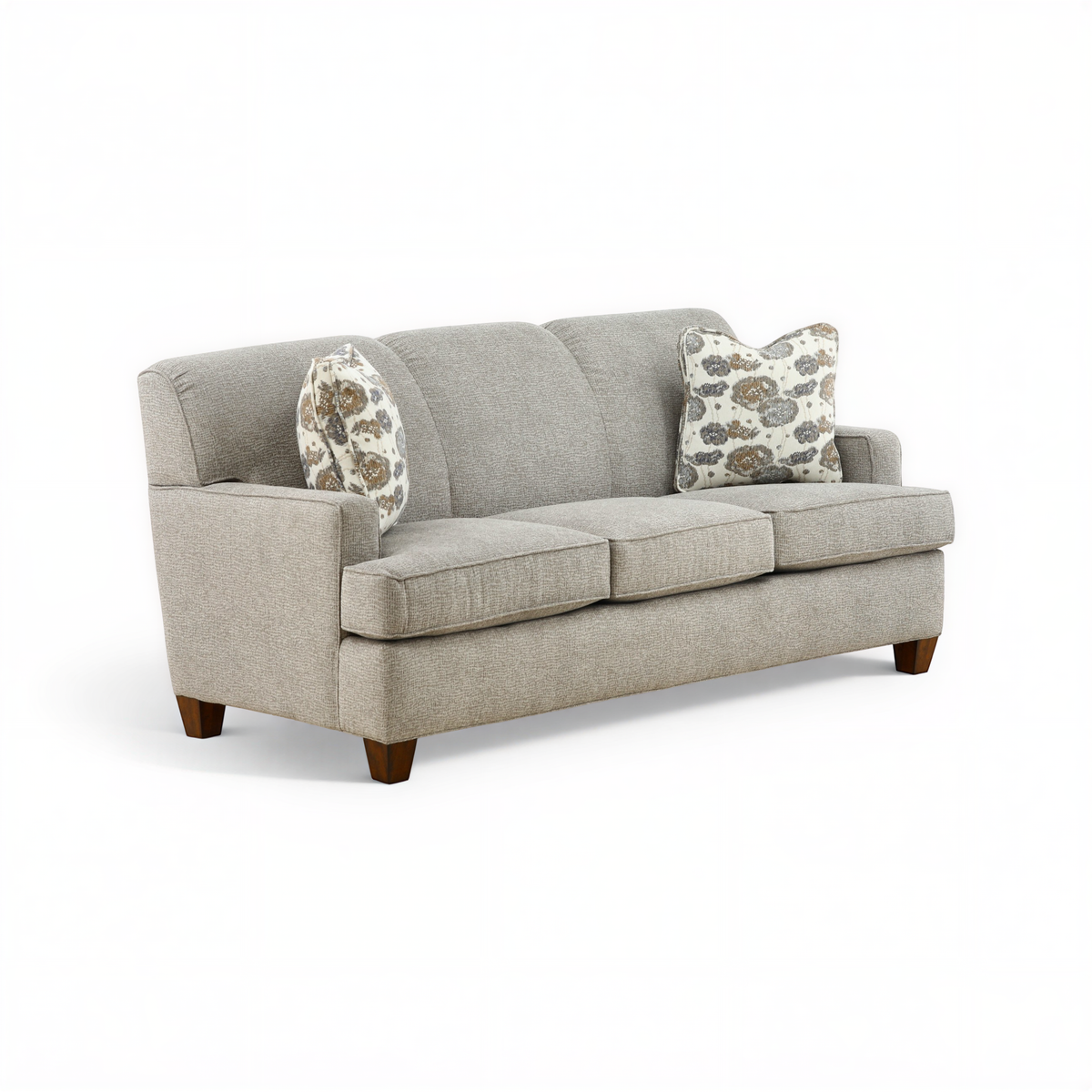 Beige upholstered sofa with two accent pillows and low wooden feet