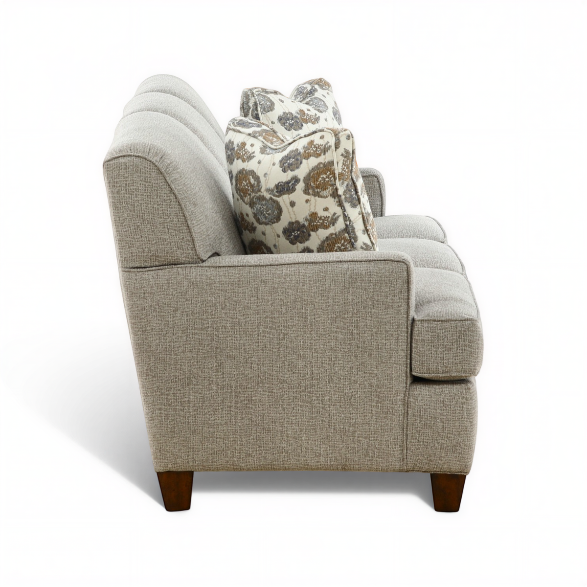 Beige sofa with two seat cushions and patterned back throw pillow