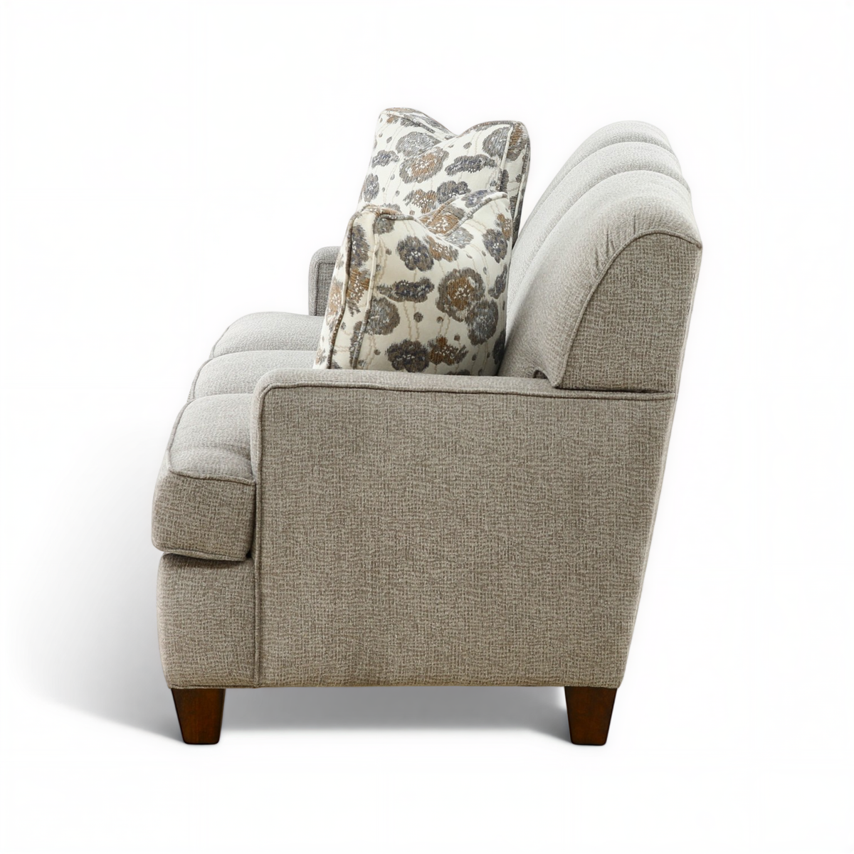 Beige sofa with rolled arms and patterned accent throw pillow