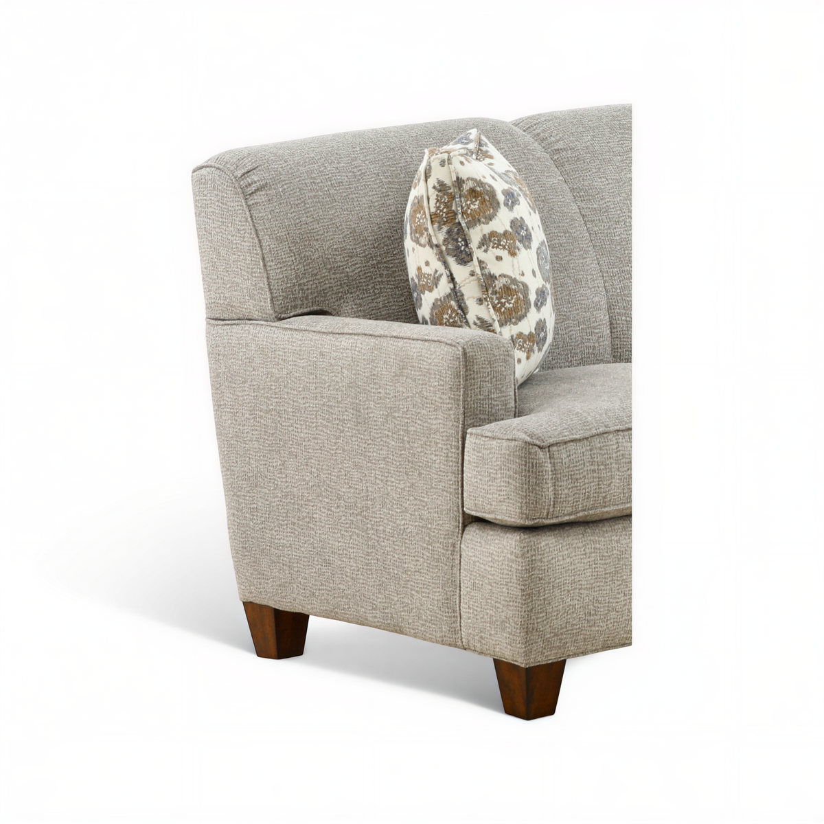 Beige upholstered armchair-style sofa with patterned throw pillow