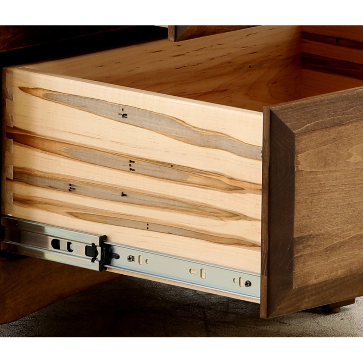 Wood nightstand drawer interior with metal slide rails and brackets