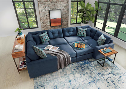 Dark blue 6-piece modular sectional sofa with chaise corner and patterned throw pillows