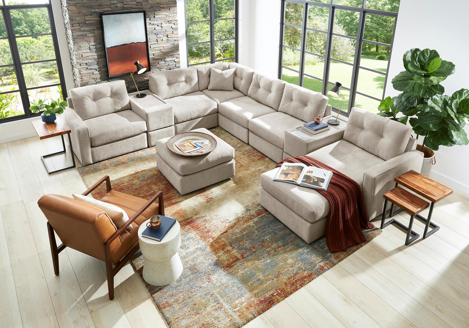 Light beige modular sectional sofa with chaise seating and decorative throw pillows.