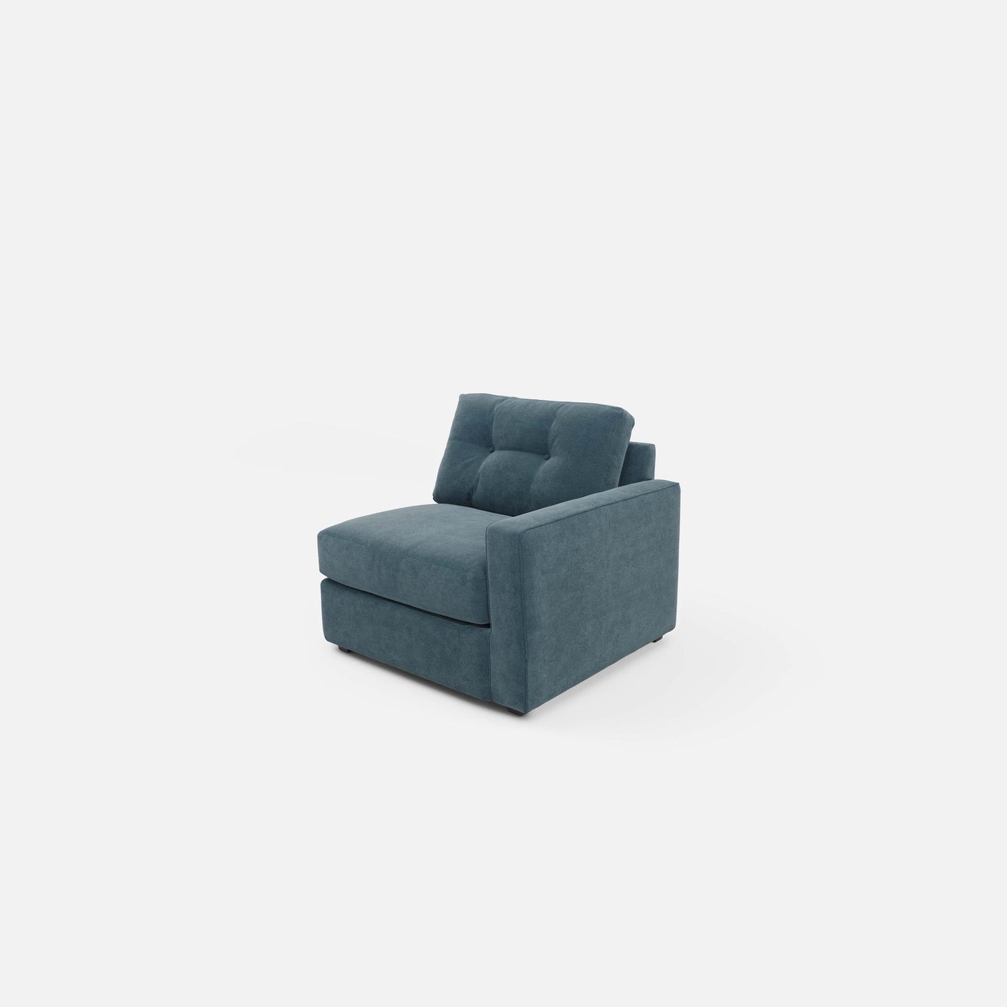 Modular chair in teal fabric with tufted back panel and squared arm sections.