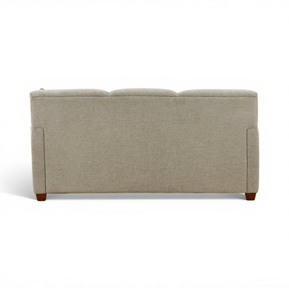 Beige upholstered sofa with boxy arms and rectangular back, exposed wooden feet