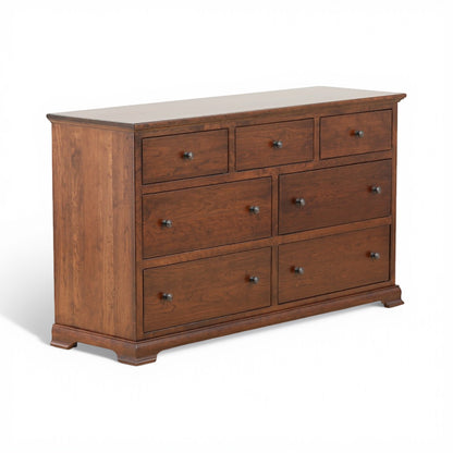 Brown wooden dresser with multiple drawers and metal pulls, corner view