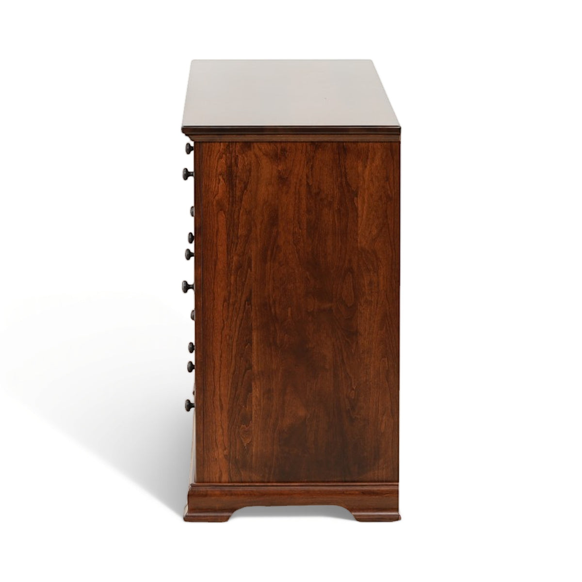 Brown wooden dresser side view with handle pulls and tapered feet