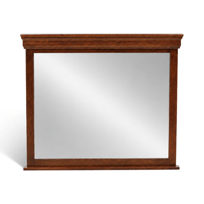 Beveled bedroom mirror with dark wood frame and rectangular glass