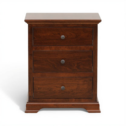 Brown wood nightstand with three drawers and round metal knobs, closed front view